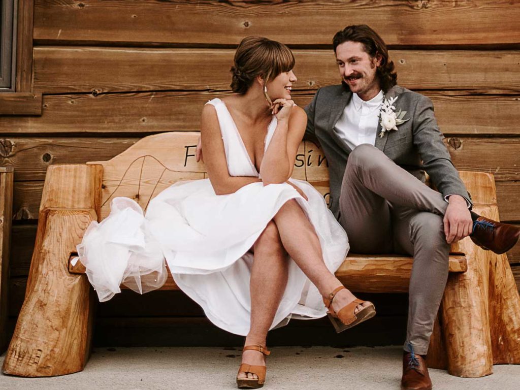 Bride And Groom On A Wooden Bench.