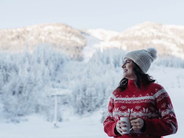 Lady Drinking A Hot Drink In The Snow.